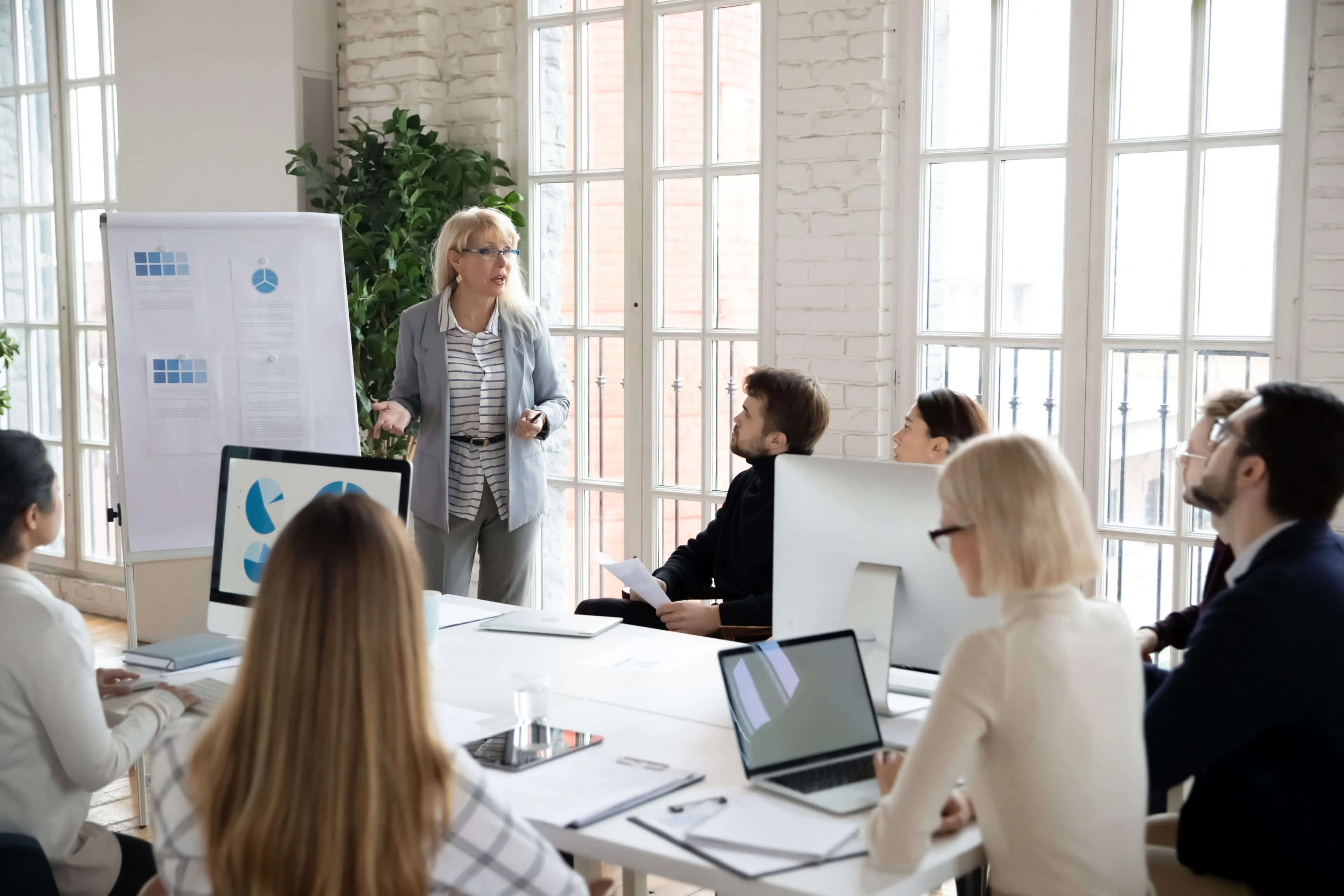 GettyImages-1245196452-1-scaled (1) Businesswoman giving a presentation to her team.